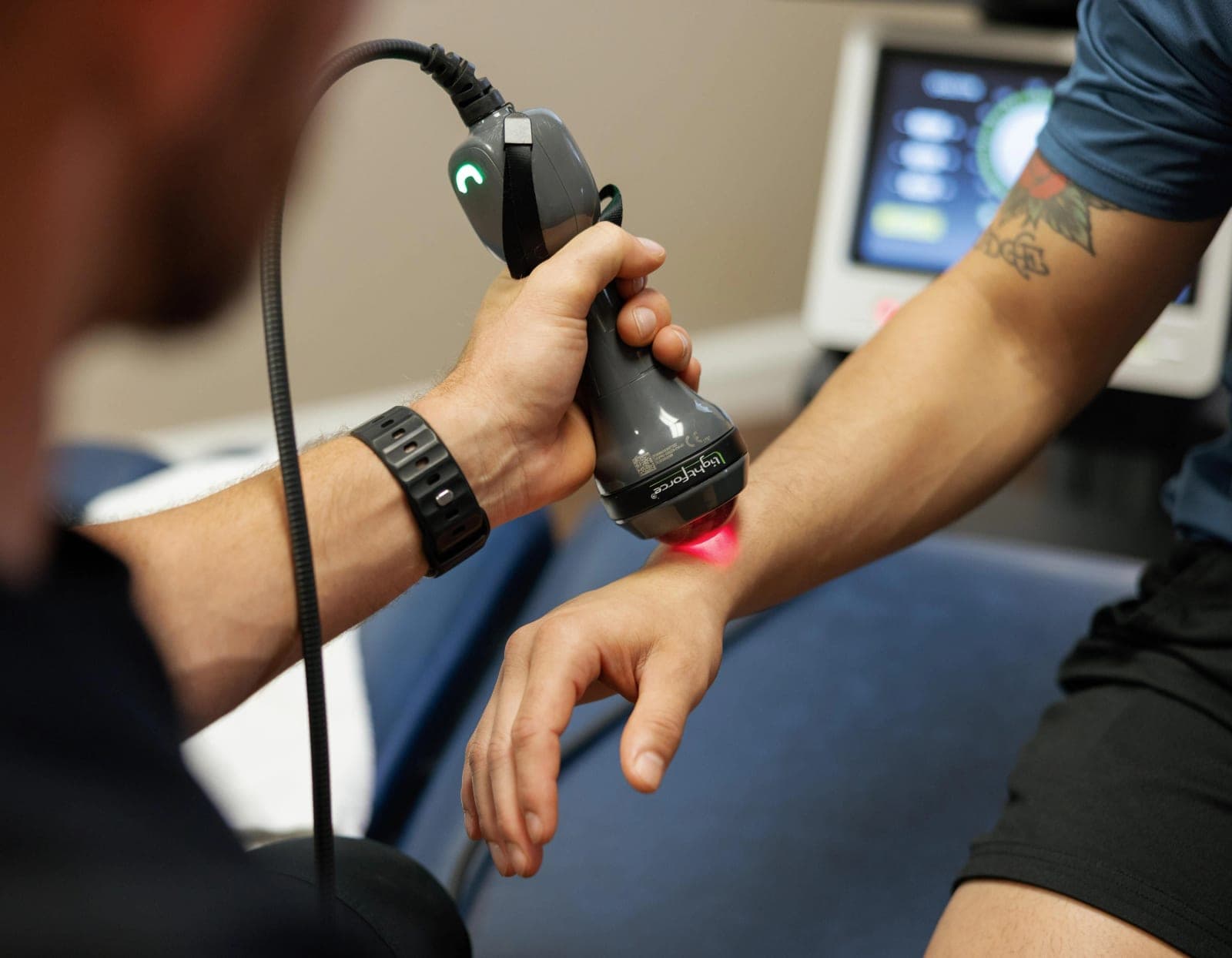 Class IV laser therapy being applied to a patient's forearm